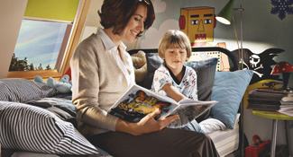 Mother reading bedtime story to son