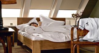 Woman sleeping in loft conversion bedroom